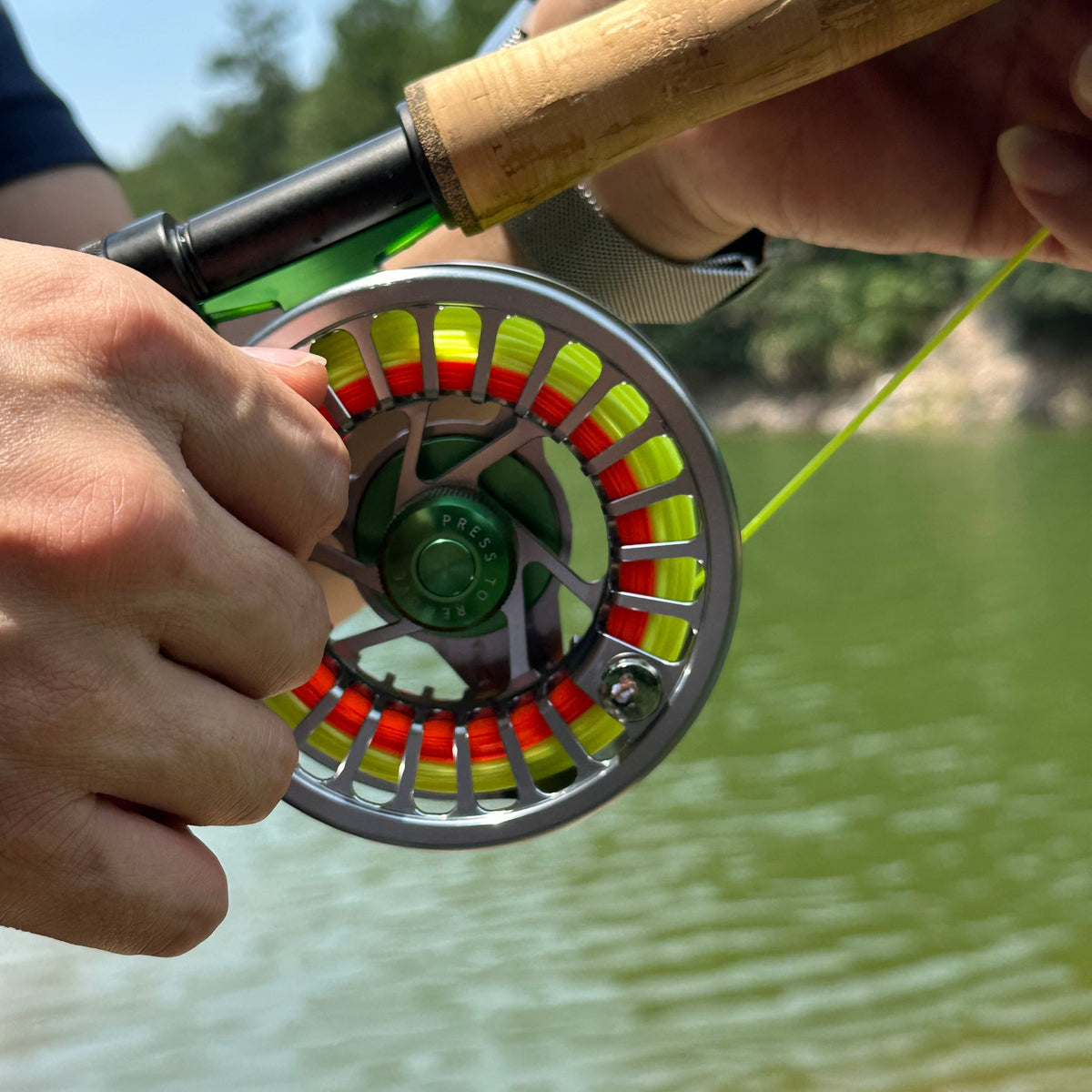 Hand-checking a KATYUSHA fly reel drag by the water